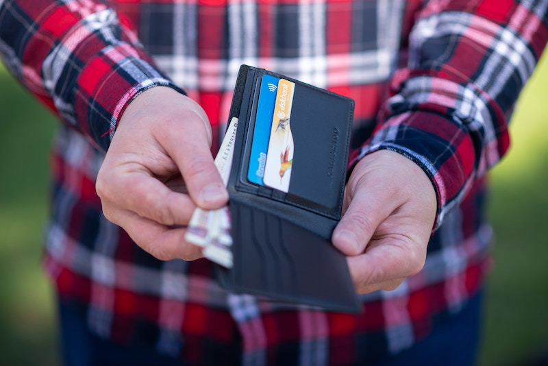 En man som lever på existensminimum visar sin plånbok